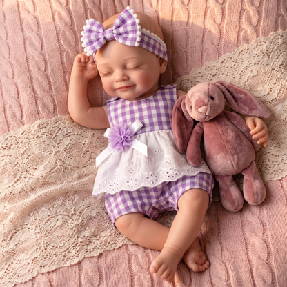 Lumi doll in purple outfit cuddling a bunny plush on a knit blanket