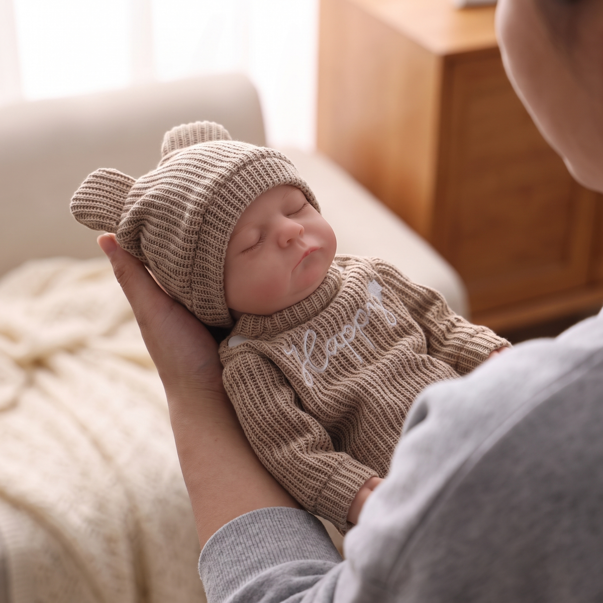 Noah doll cradled in arms